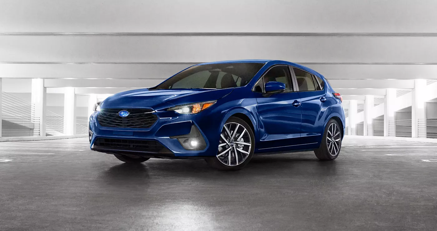 A blue Subaru Impreza in a studio, front three-quarter view