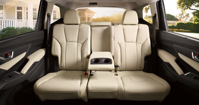 An armrest in the rear of a Subaru Ascent full-size SUV with two cup holders.
