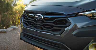 The front grille of a Crosstrek Hybrid AWD SUV.