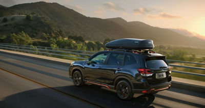 MY20 Forester with cargo driving with mountains in background