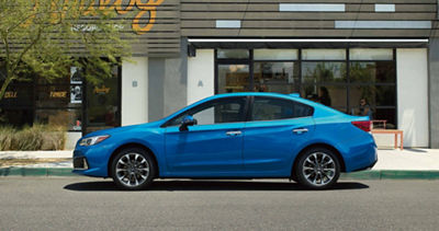 MY20 Impreza parked at curb outside of storefront