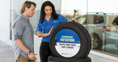 Saleswoman selling tires to a male customer. 