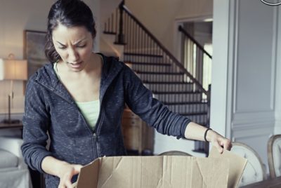 woman frowning at damaged packaging