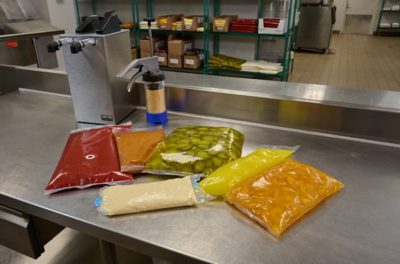 Flexible packages of liquid food products on a metal table