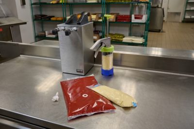 flexible fluid food packaging on a metal table 