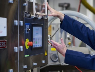 worker performing maintenance on equipment