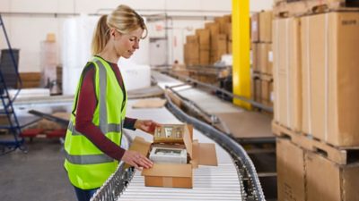 warehouse worker packing boxes