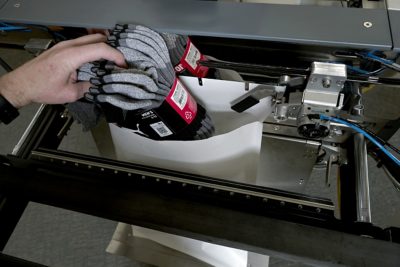 man loading socks into 850S bagging and printing system