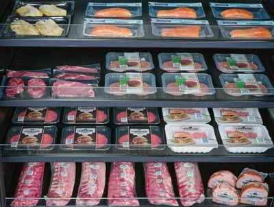 assorted meat trays on grocery store shelf