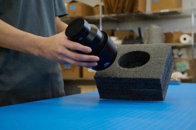 man placing product into foam packaging