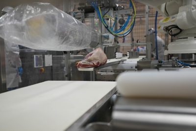 meat being loaded into a plastic bag