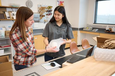 two women examining bubble wrap