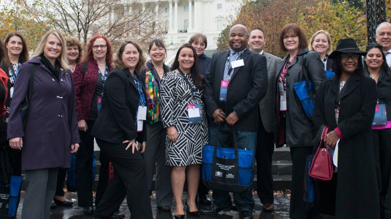 Group of women and men conference attendees smiling