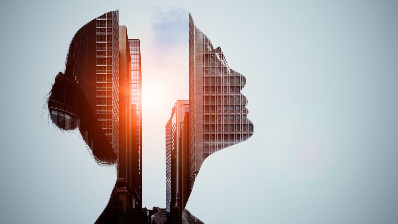 A woman's head with buildings in the background.