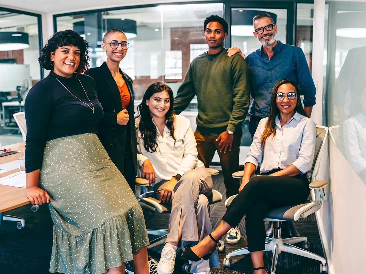 Team smiles in their office space. 