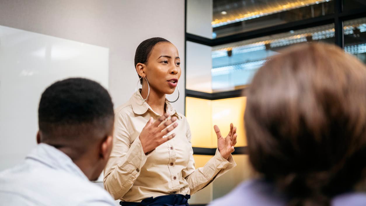 A woman giving a presentation to a group of people.