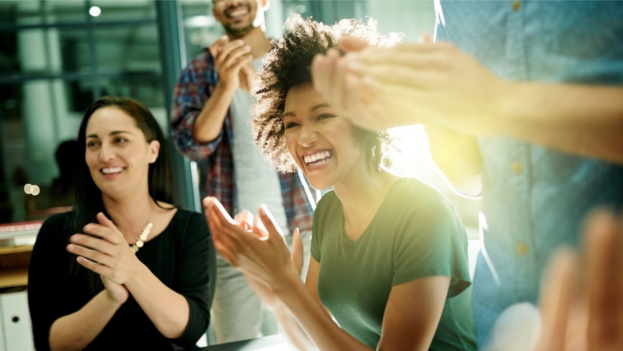 Colleagues celebrating during a meeting. 