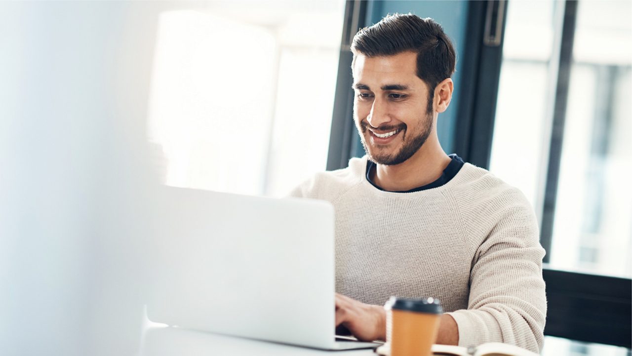 Employee smiles during online course.