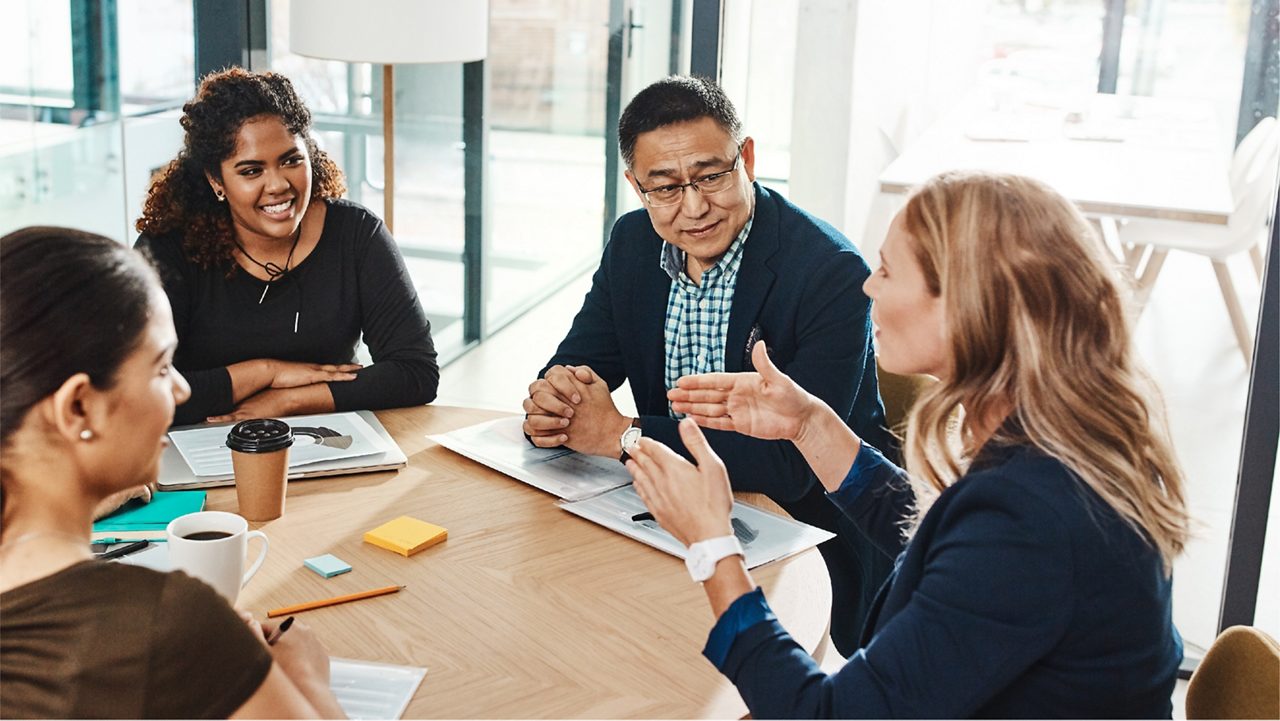 coworkers meet at a conference table