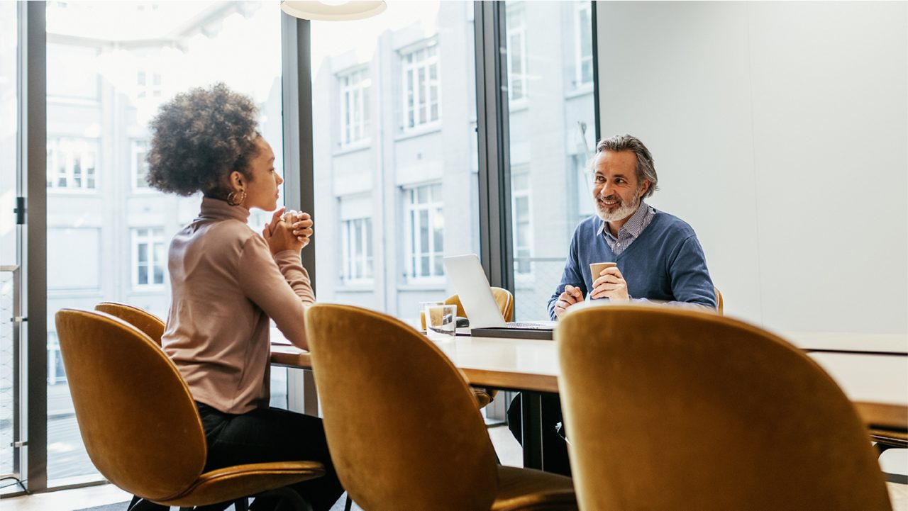 man and woman meet at a conference table