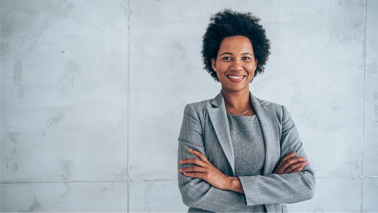 Woman smiles proudly at the camera.