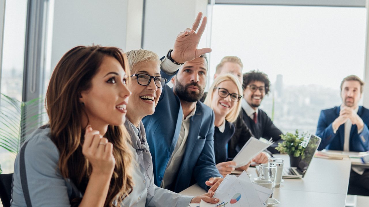 Group of enthusiastic people around a conference table