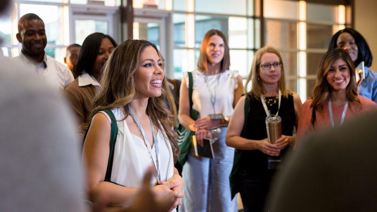 group of people wearing lanyards at a conference