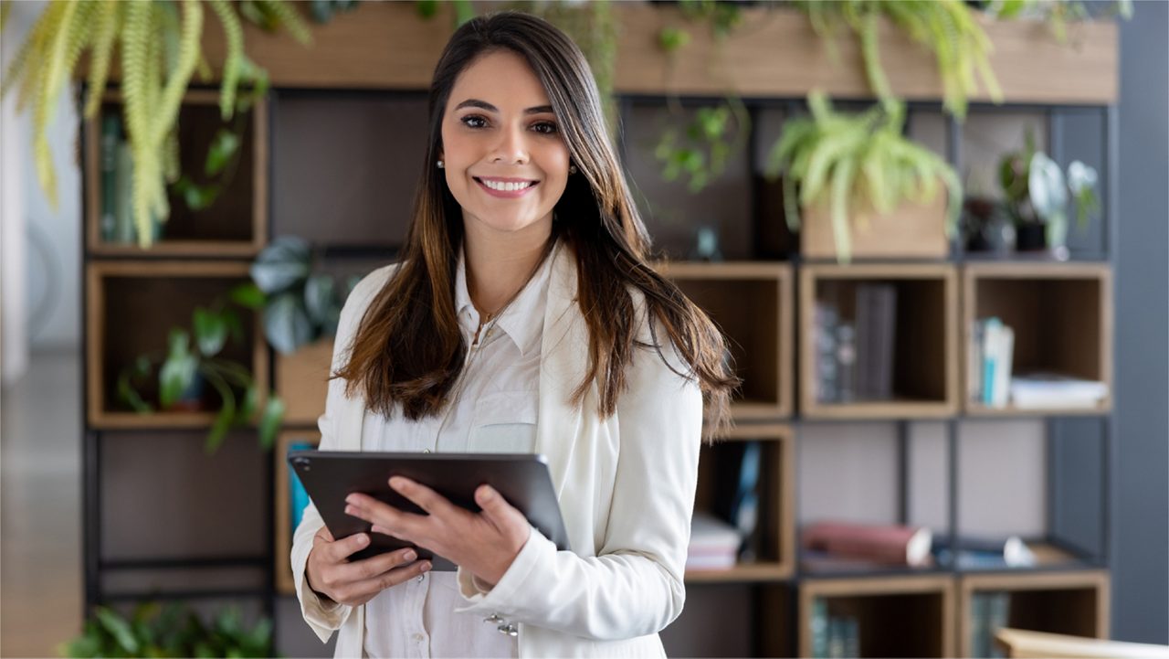 Woman smiles with tablet.