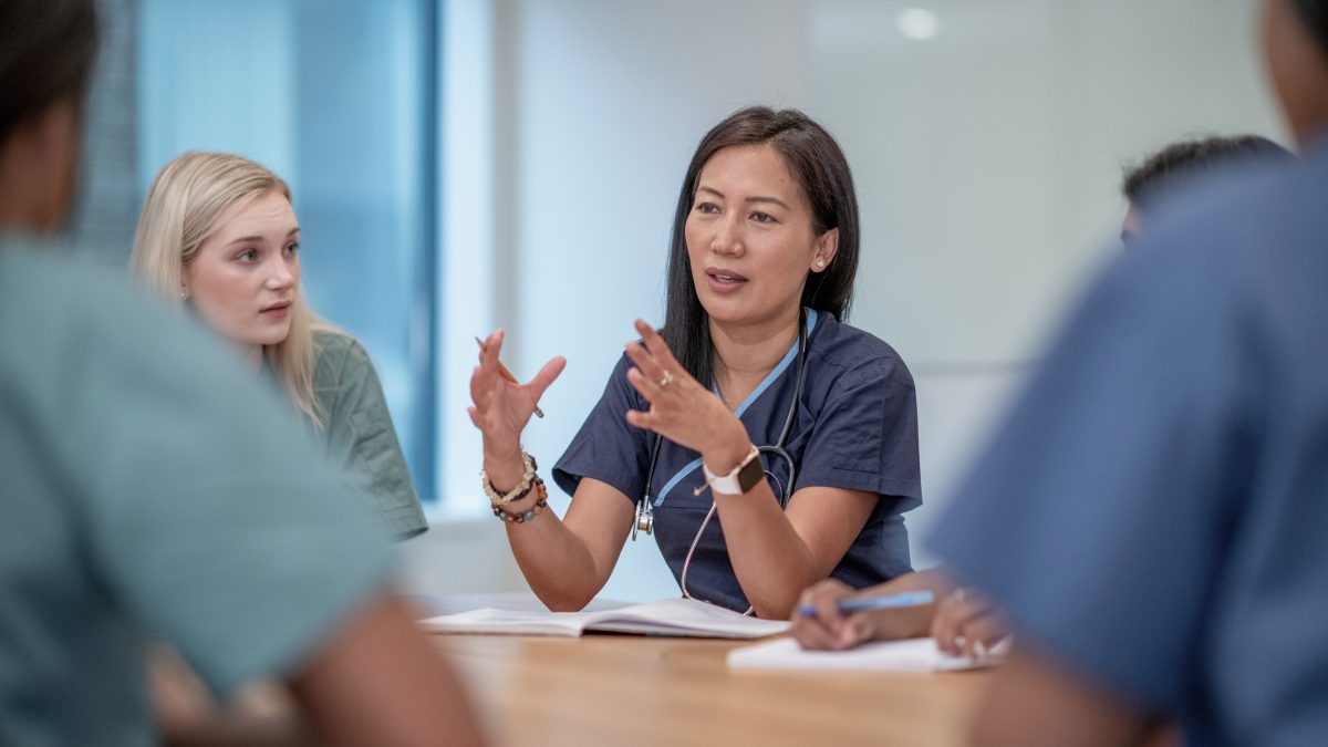 doctor speaking to a room of nurses