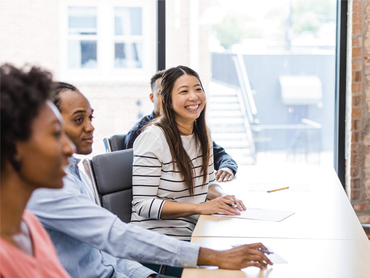 Employee laughs during an informational session.