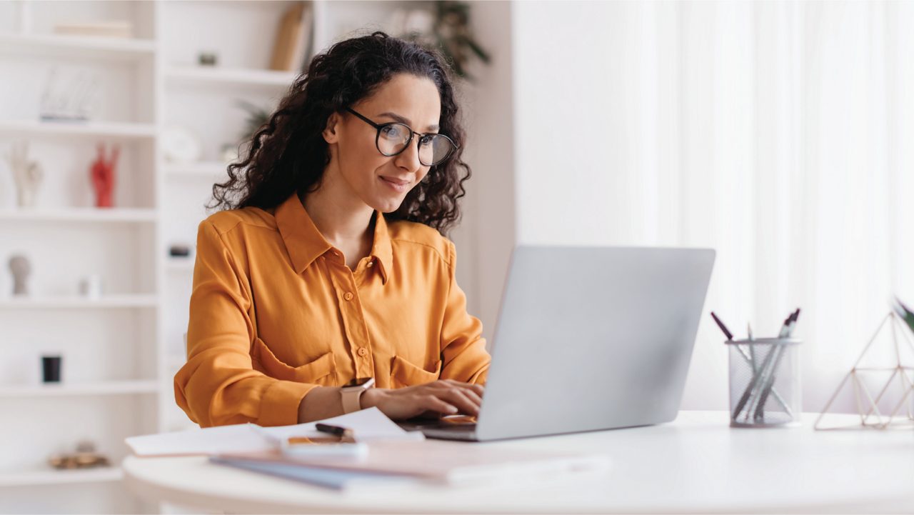 Woman works on her laptop.