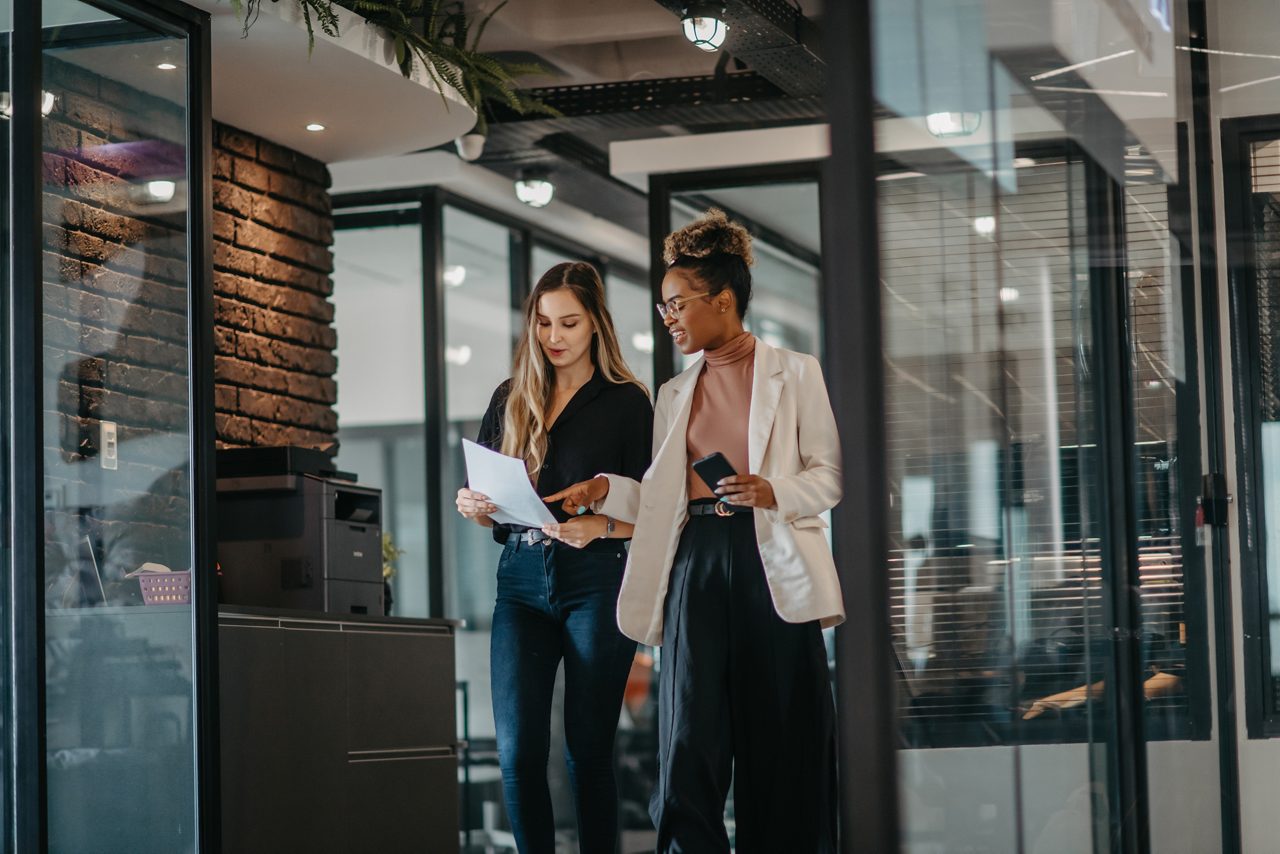 young female employees walking down the company corridor