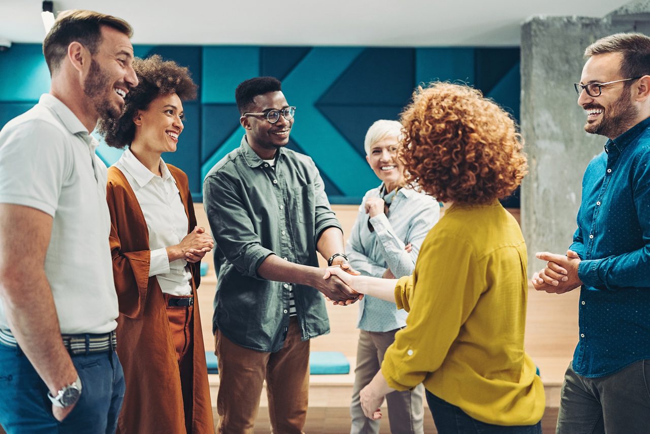 Smiling business persons shaking hands