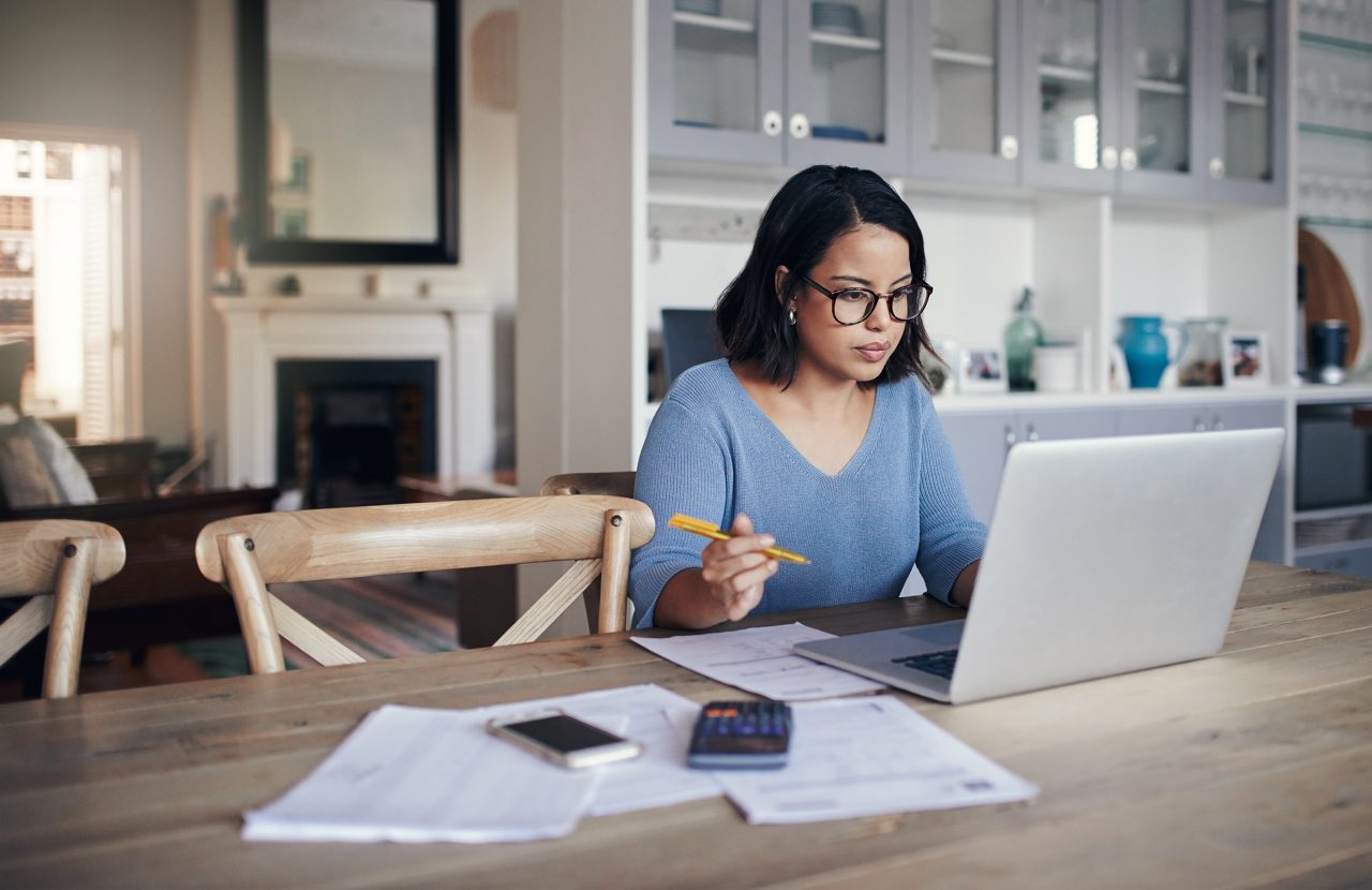 Shot of a young woman using a laptop while working from home