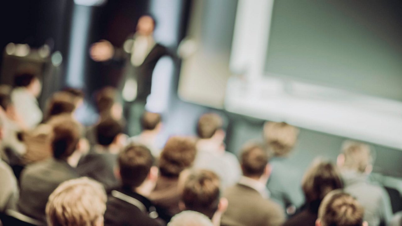 A man is giving a presentation to a group of people.