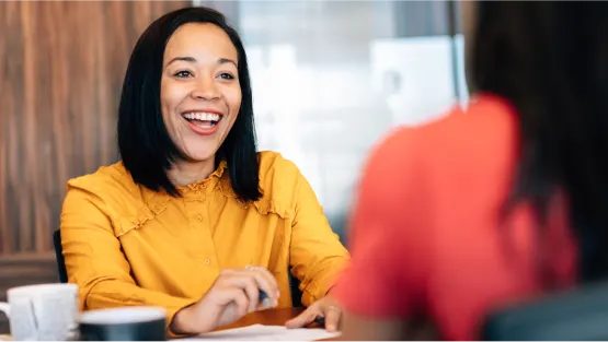 woman smiling in yellow shirt