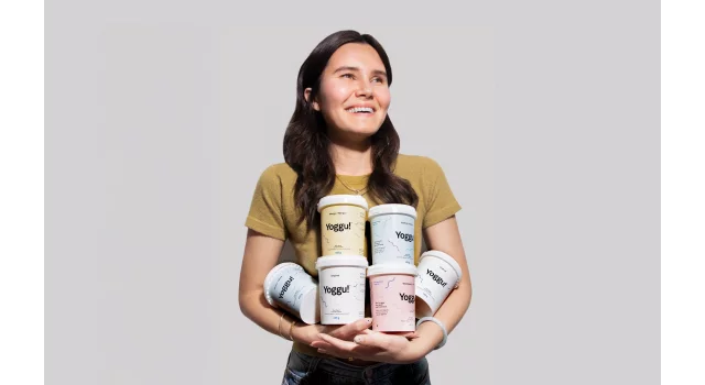 Jade Herman from Yoggu holding products