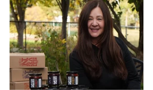 Natalia from Seven Spice holding packaged products