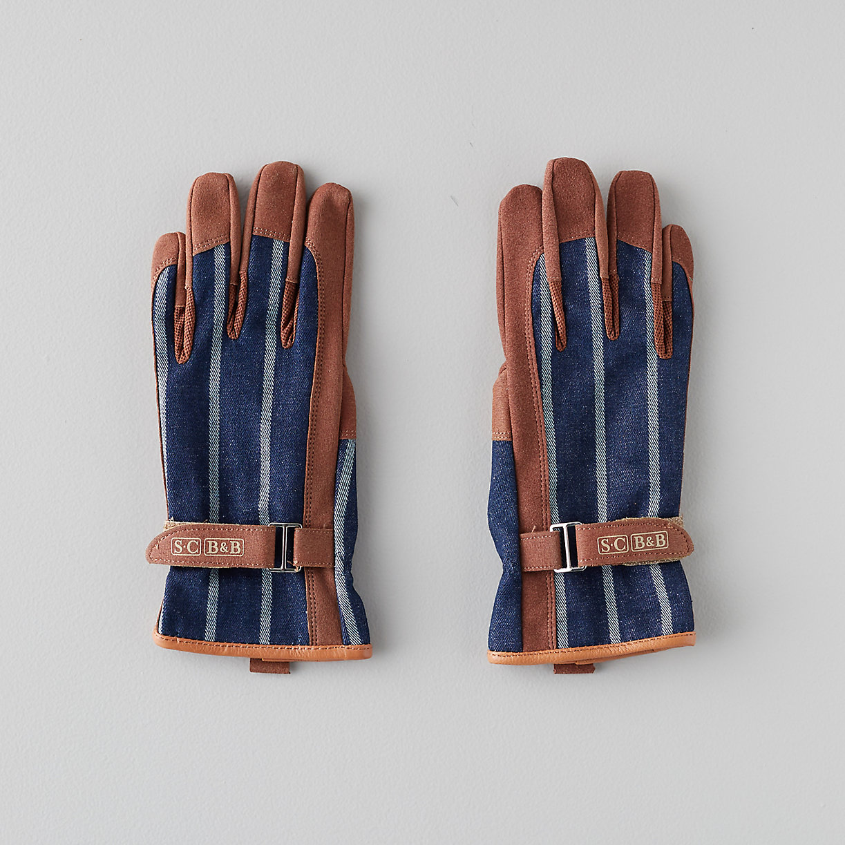Two leather gloves with a blue and white strip design.
