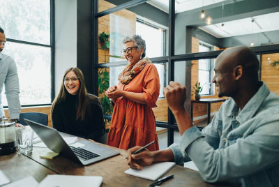 Click image of group of coworkers at conference table laughing at joke to navigate to page: Governance & accountability