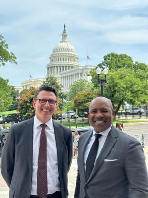 Two men in suits near the U.S. Capitol