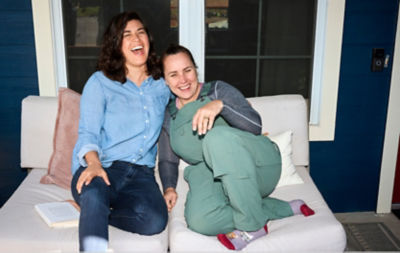 Friends relaxing on couch laughing