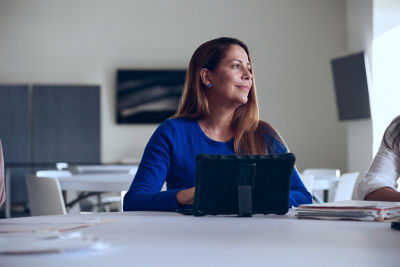 Woman using a tablet, representing TIAA customer support services