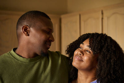 Smiling couple, conveying warmth and financial confidence.