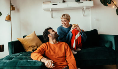 Smiling couple gazing at each other while discussing retirement planning strategies and aligning their financial goals for the future