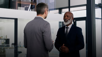 Two men standing having a discussion