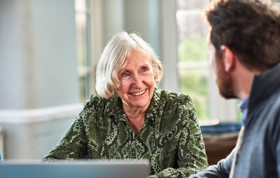 Elderly woman talking with financial advisor about establishing a personal trust