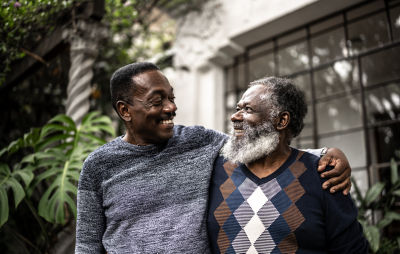 A father and son smiling in a warm embrace