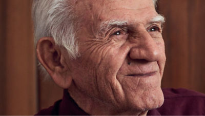 A smiling gray-haired man