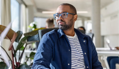 A professor sitting at his desk content